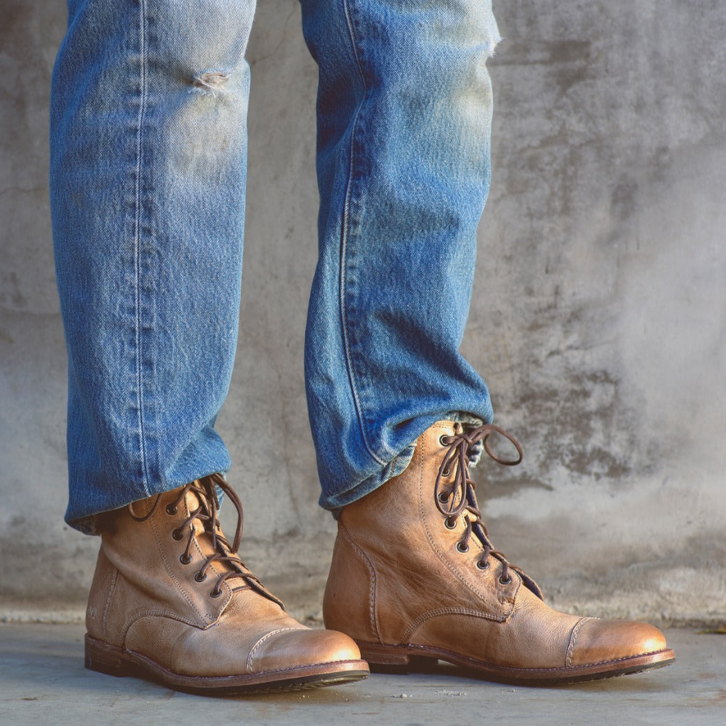 A man wearing a pair of Bed Stu Protege tan lace up boots.