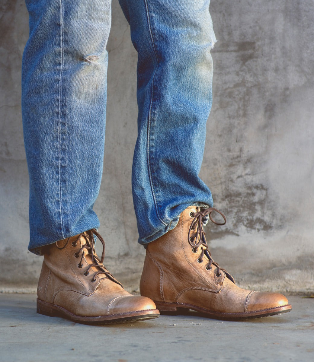 A man wearing a pair of Bed Stu Protege tan lace up boots.