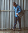 A man walking with a Bed Stu Protege Trek bag.