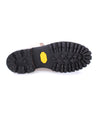 A pair of Bed Stu Protege Trek shoes with yellow soles on a white background.