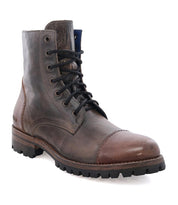 Brown leather lace-up Protege Trek boot by Bed Stu with a rugged Vibram outsole and a visible logo on the side, isolated on a white background.