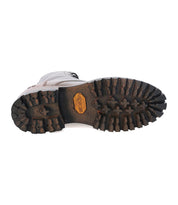 Bottom view of a worn hiking boot showing detailed tread pattern and a visible Bed Stu Vibram outsole on the heel.