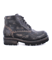 A black leather Quatro III boot with studs and by Bed Stu.