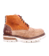 A pair of Bed Stu Quatro III brown and tan boots with a white sole.