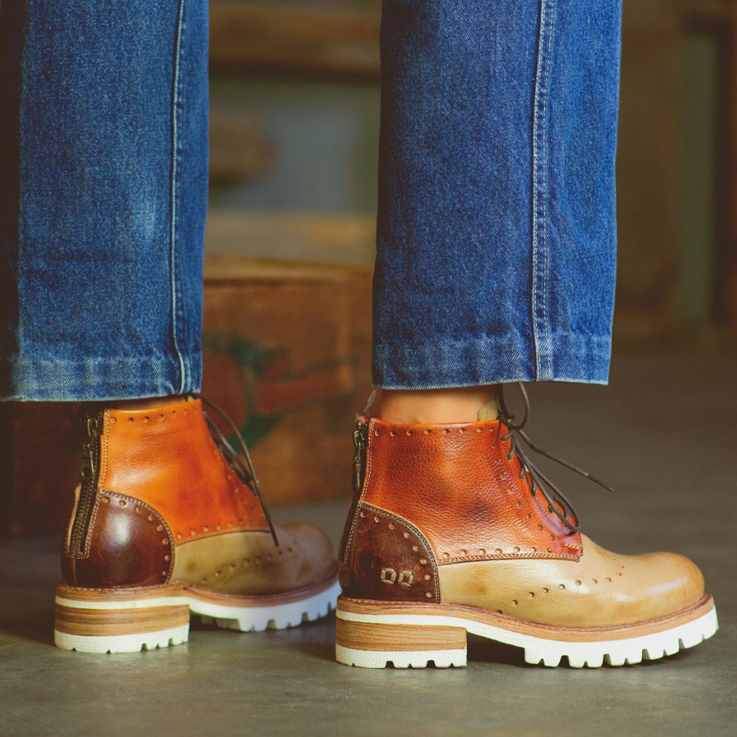 A pair of Bed Stu Quatro III boots on a person's feet.