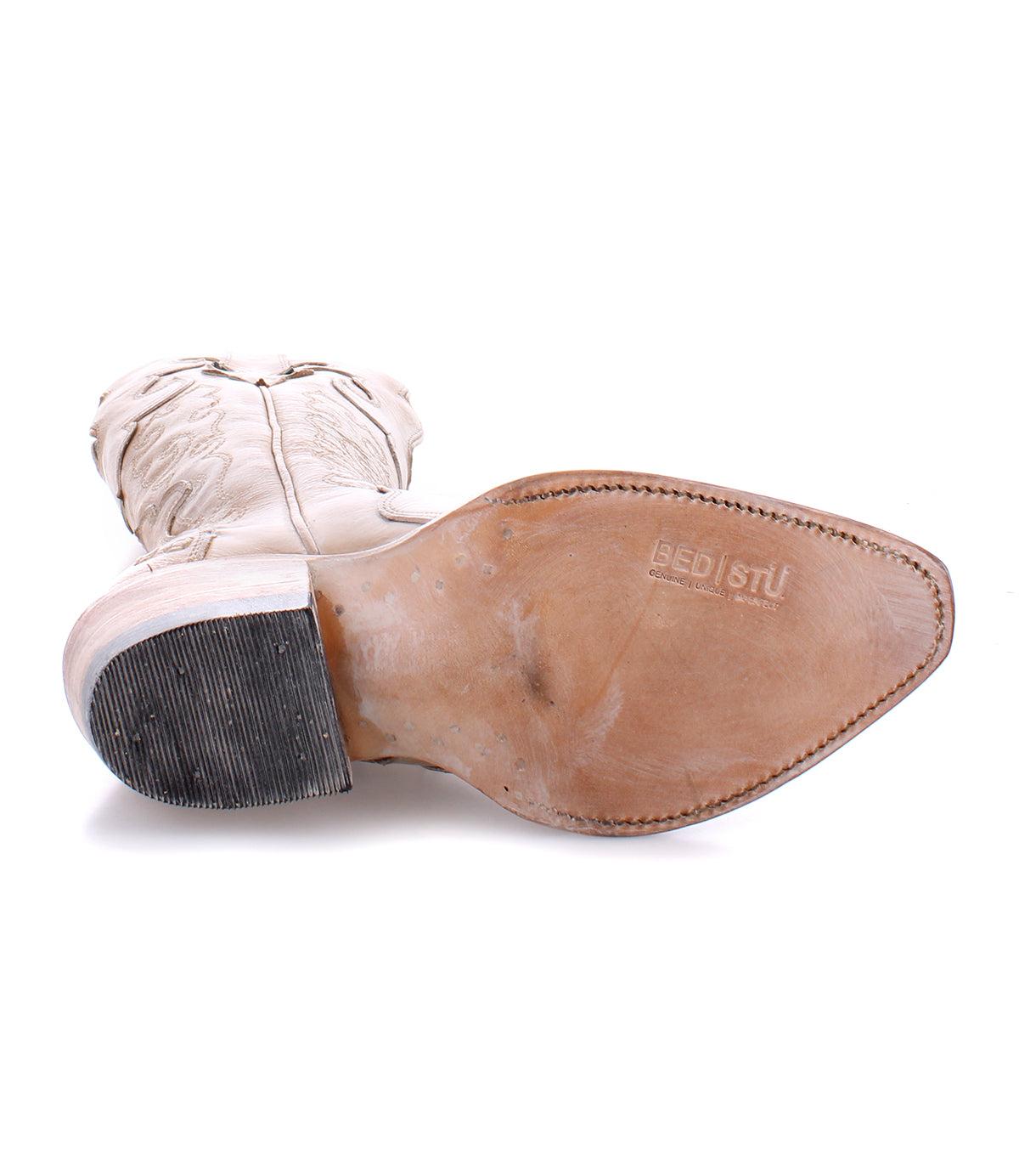 A pair of tall white Bed Stu Queen cowboy boots on a white background.