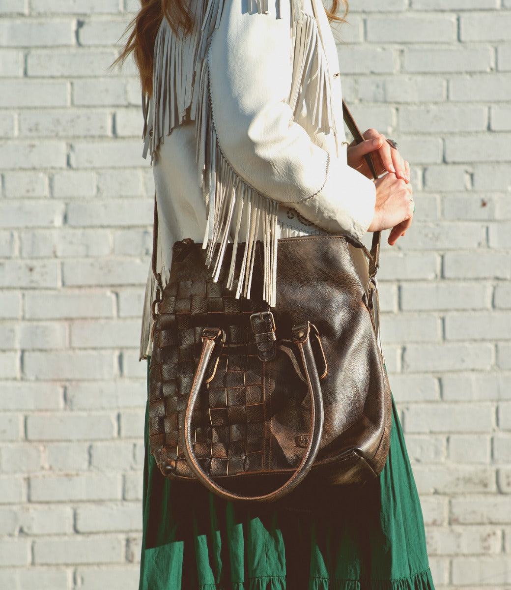 A woman in brown jacket and green skirt wearing the Rachel bag from Bed Stu.