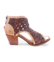 The Ransom by Bed Stu is a brown woven leather sandal featuring a chunky wooden heel, open-toe design, and back zipper closure. Handmade from vegetable-tanned leather, these exquisite peep-toe heels showcase exceptional artisan craftsmanship.