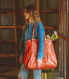 A woman carrying a Rebekah tote bag made by Bed Stu.