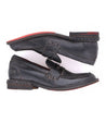 A pair of Reina loafers by Bed Stu with red soles.