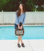 A woman standing by a pool wearing Reina shoes by Bed Stu.