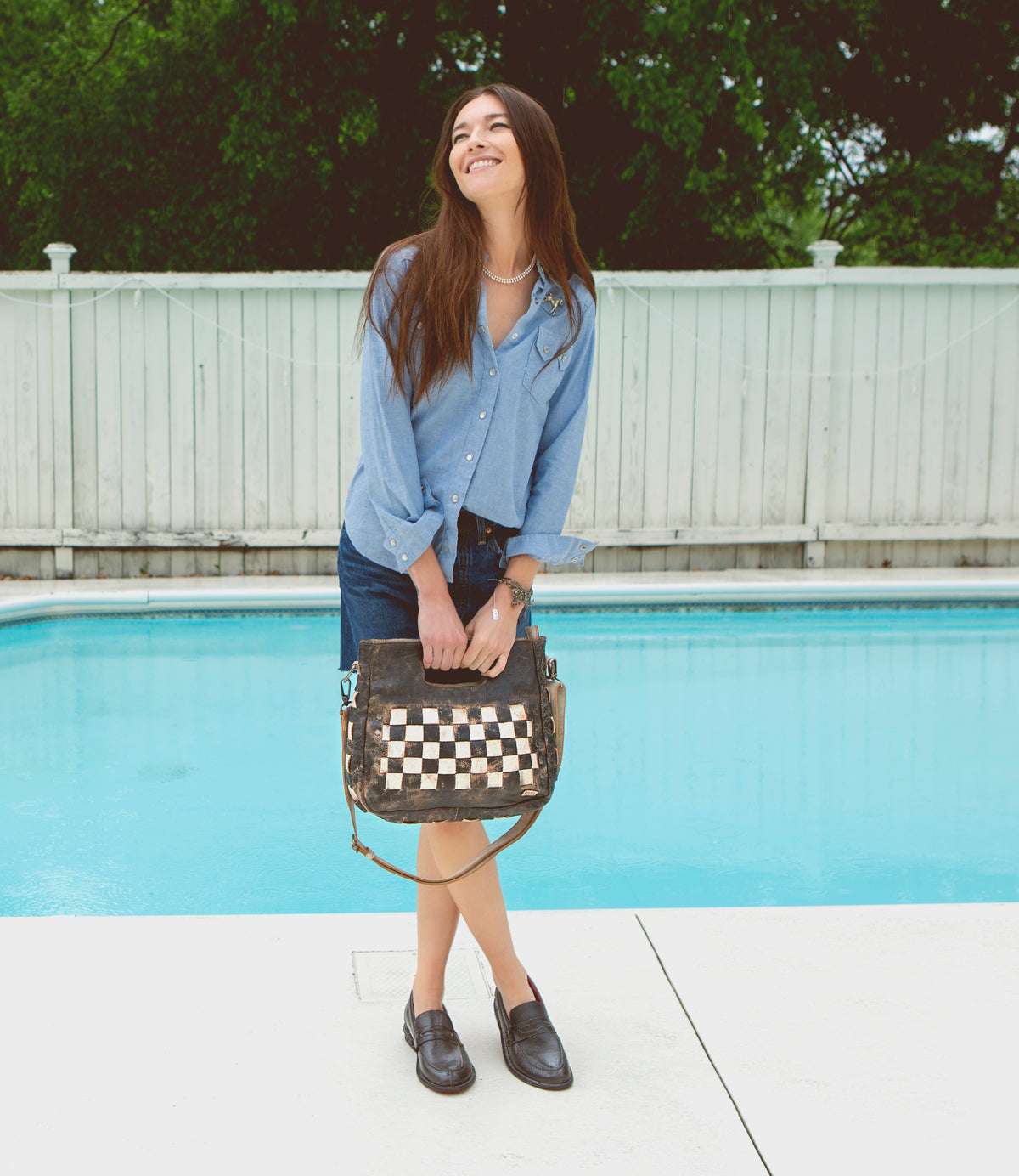 A woman standing by a pool wearing Reina shoes by Bed Stu.