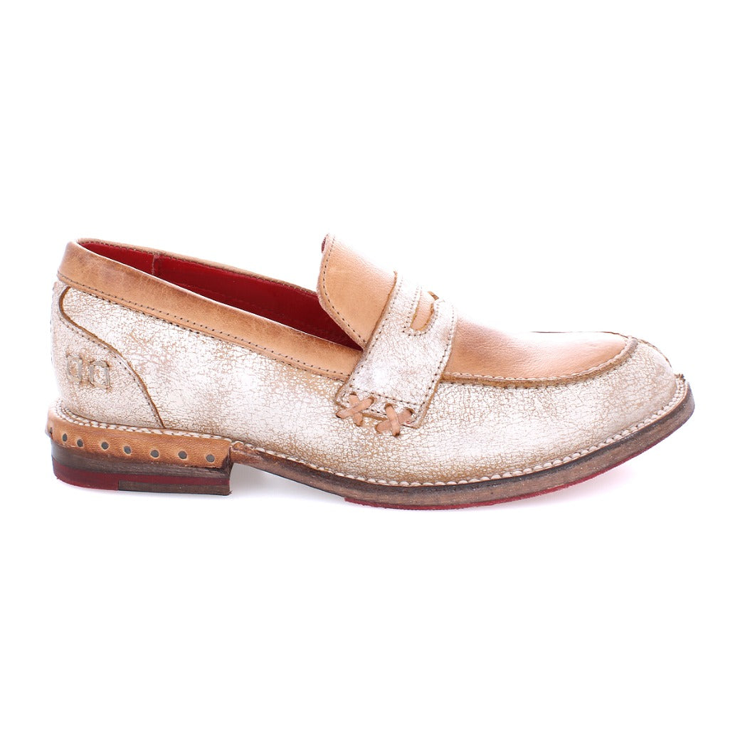 A Reina women's loafer in beige with a red sole by Bed Stu.