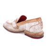 A beige Reina loafer with red soles by Bed Stu.