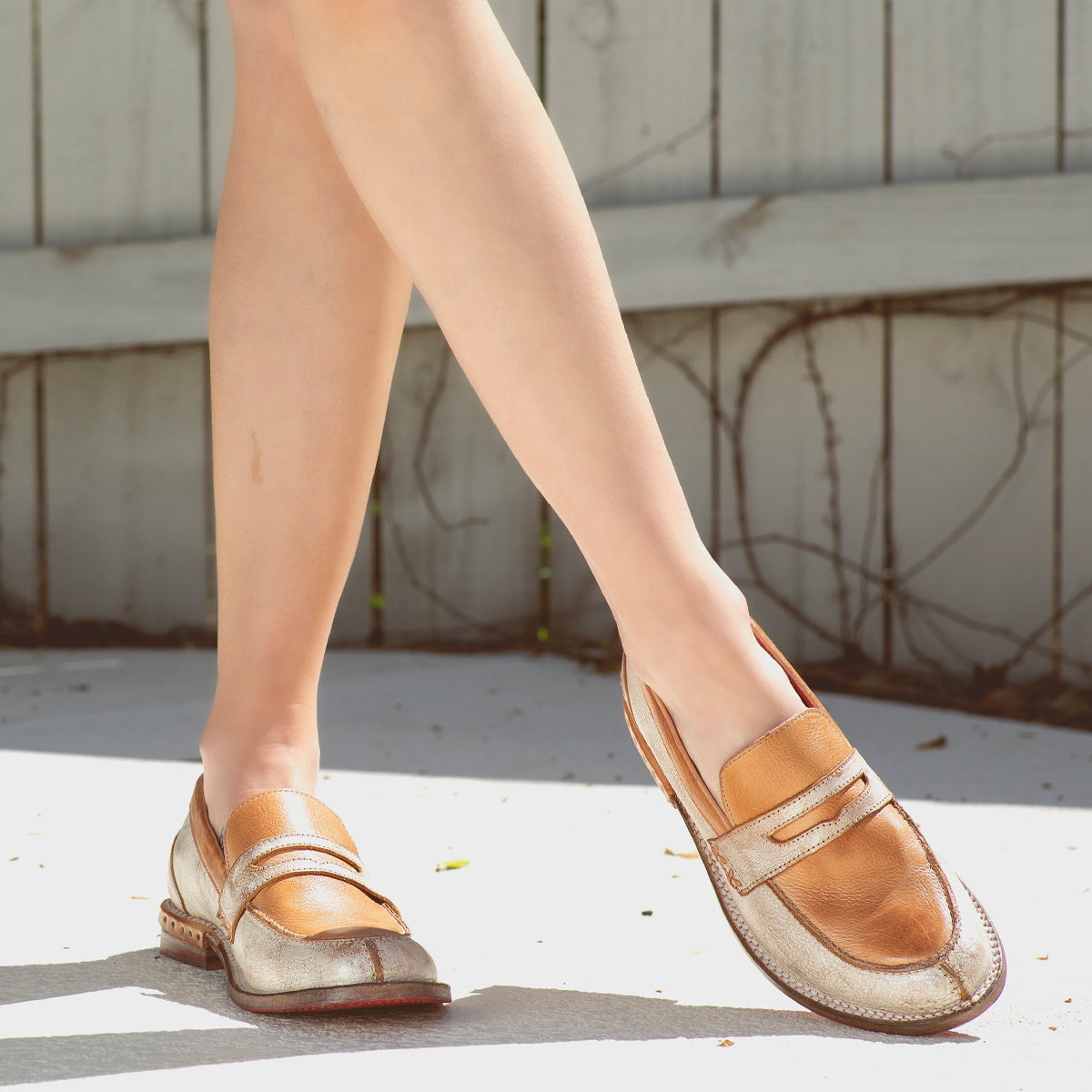 A woman wearing a pair of Bed Stu Reina loafers.