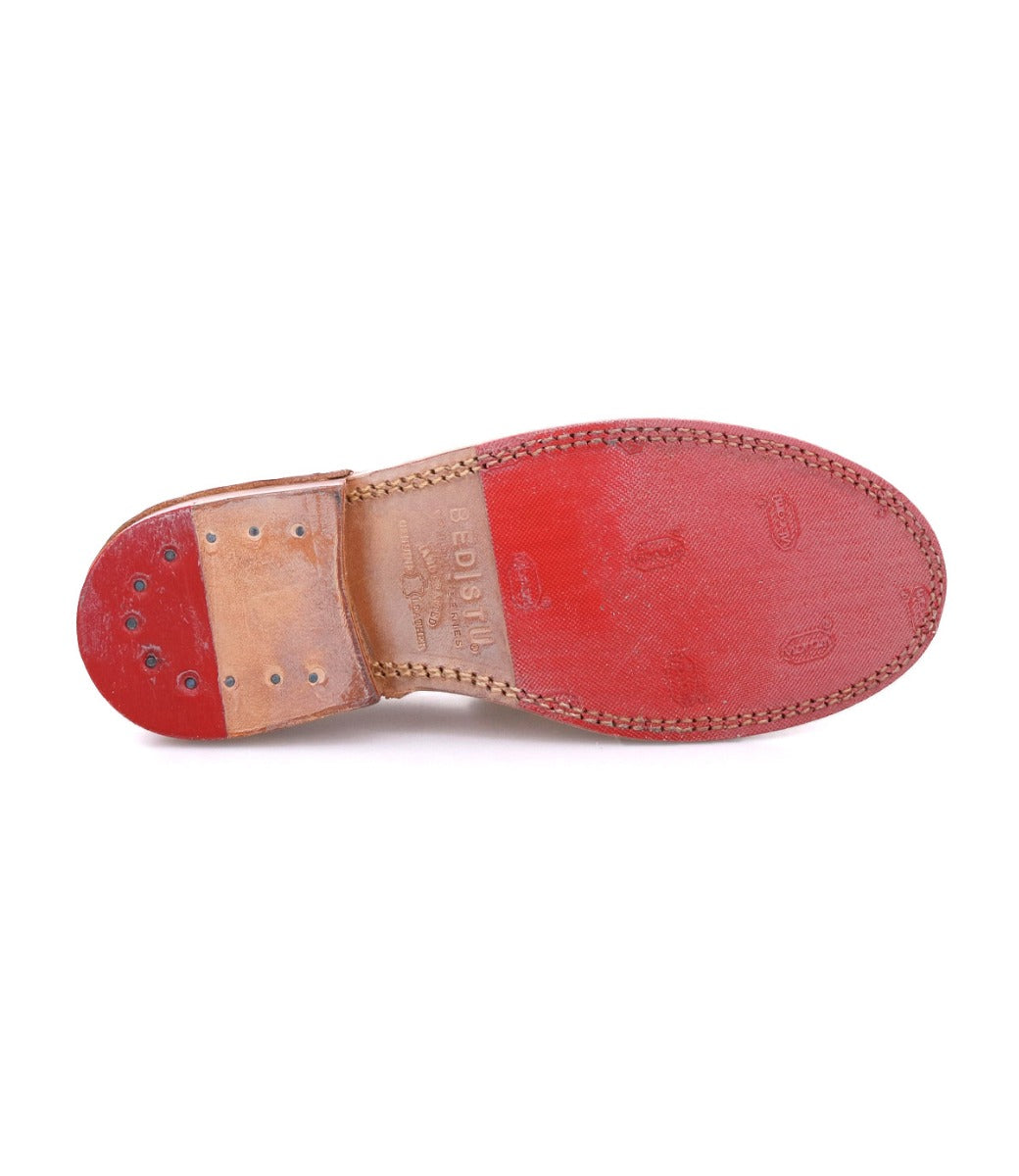 A pair of Reina red shoes with brown soles by Bed Stu.