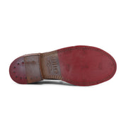 A pair of Bed Stu Reina shoes with red soles on a white background.
