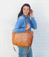 A woman wearing jeans and a Bed Stu Renata LTC tote bag.