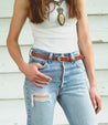 A woman wearing Rico jeans and a Bed Stu belt.