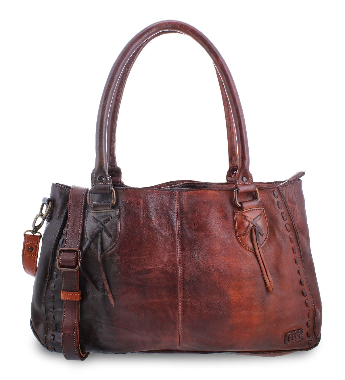 The Rockababy by Bed Stu is a leather handbag featuring comfortable padded shoulder straps, a front pocket tied with leather strings, and a detachable, adjustable strap. The bag showcases stitch detailing along the edges and includes a small leather tag.