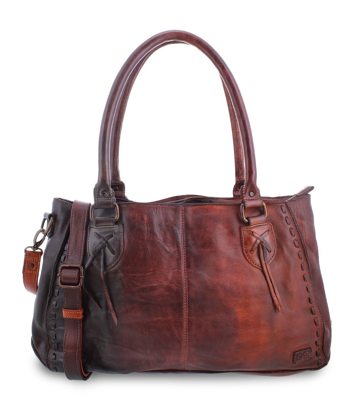 The Rockababy by Bed Stu is a leather handbag featuring comfortable padded shoulder straps, a front pocket tied with leather strings, and a detachable, adjustable strap. The bag showcases stitch detailing along the edges and includes a small leather tag.