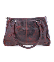 The Bed Stu Rockababy is a large, dark brown leather handbag featuring two handles and decorative stitching on the edges, seamlessly blending practicality with elegance for a stylish everyday bag.