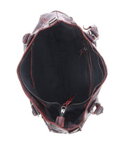 Top view of an open brown leather Bed Stu Rockababy bag with a dark interior, featuring a zipper pocket and a lined compartment. This stylish everyday bag is both elegant and functional.