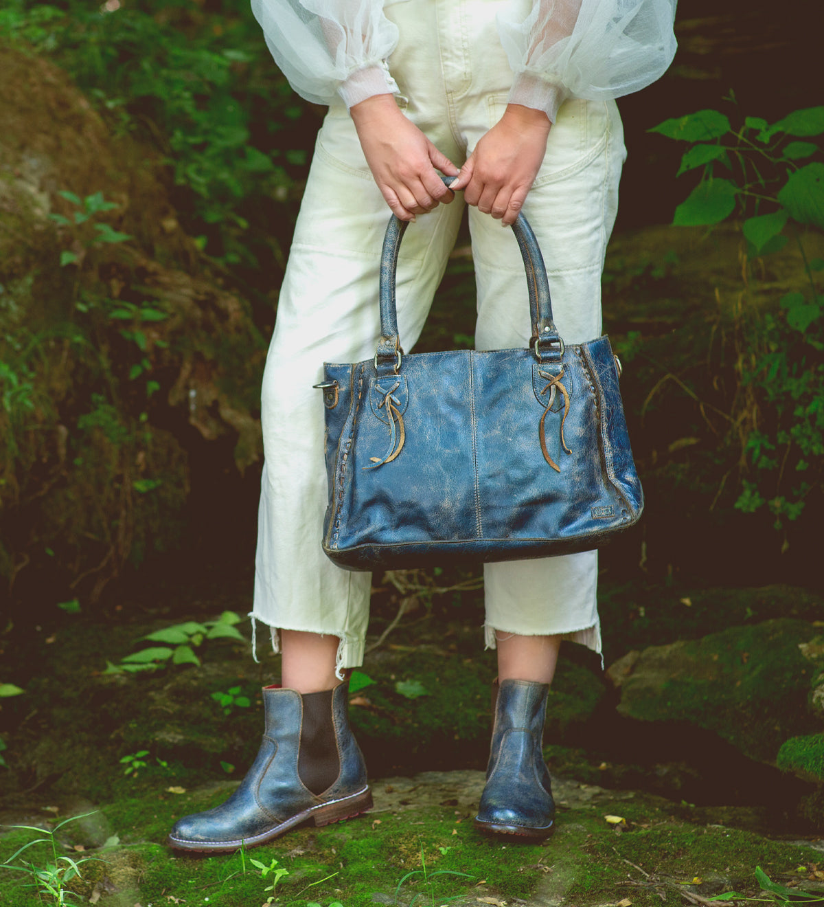 A woman holding a Rockababy leather handbag by Bed Stu.