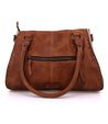 A Rockababy by Bed Stu in tan leather handbag with a zippered closure.