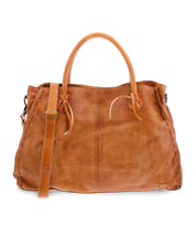 The Rockaway by Bed Stu is a fan favorite tan leather handbag featuring dual handles, an adjustable shoulder strap, and a stitched design along the edges. For added convenience, it also includes a zip-pocket divider.