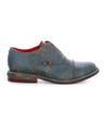 A pair of Bed Stu men's blue Rose shoes with a red sole.