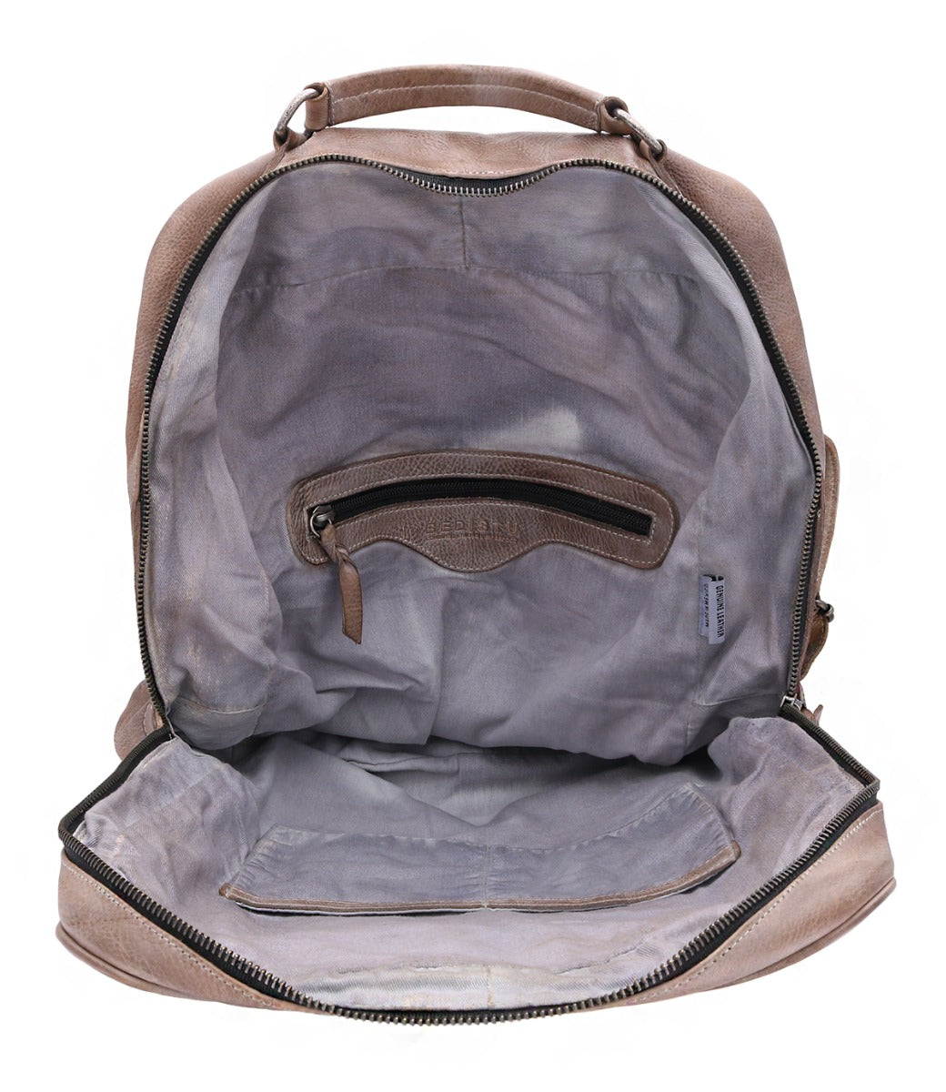 The inside of a Bed Stu backpack with a zippered compartment.
