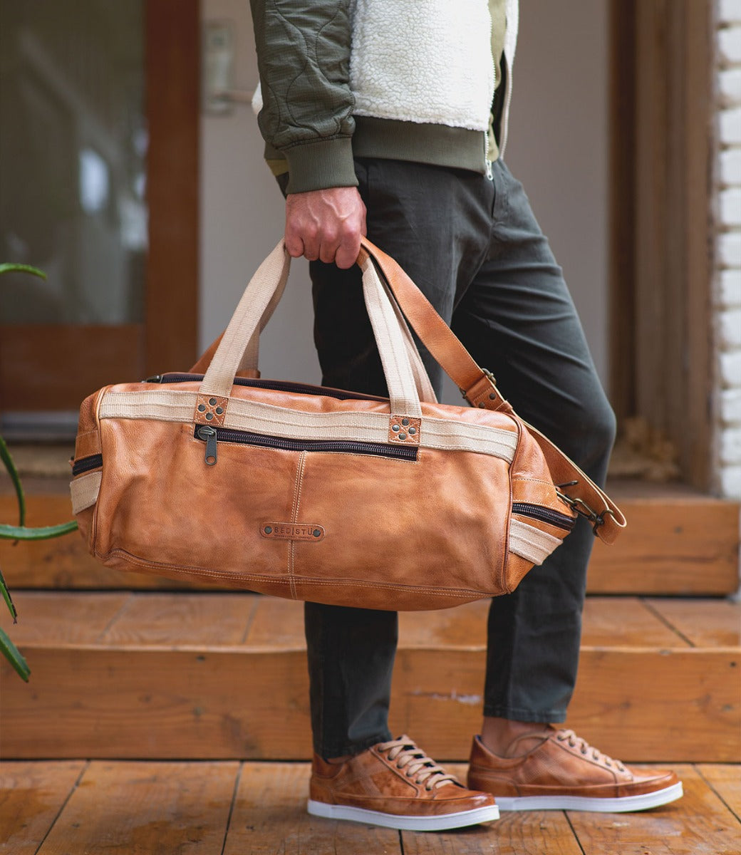 A man carrying a Ruslan duffel bag by Bed Stu.