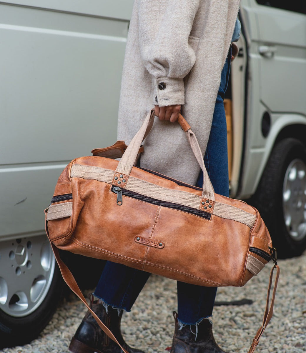 A man carrying a Ruslan duffel bag by Bed Stu.