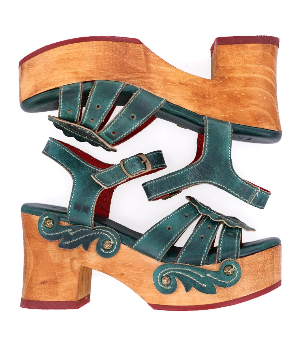 A pair of green wooden Sabine sandals with a Bed Stu wooden heel.