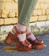 A woman wearing a pair of Sabine platform sandals by Bed Stu.