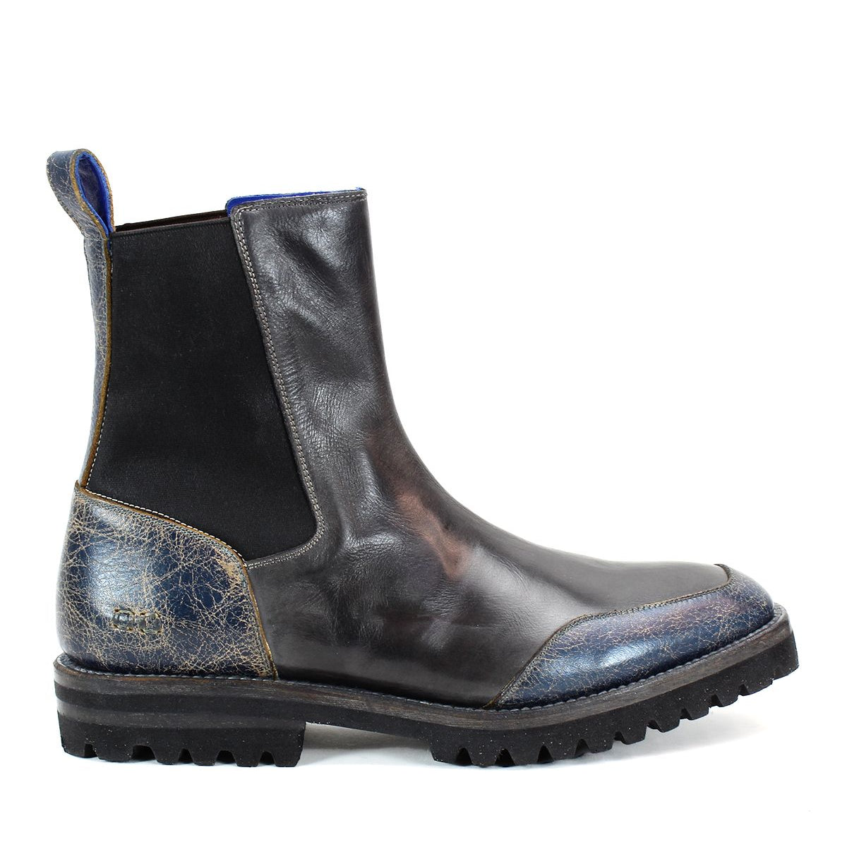 The Salatiel Chelsea boot from Bed Stu, crafted in black and blue leather, showcases a side view of its elastic panels and rugged sole, delivering a timeless style with unmatched comfort.