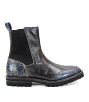 The Salatiel Chelsea boot from Bed Stu, crafted in black and blue leather, showcases a side view of its elastic panels and rugged sole, delivering a timeless style with unmatched comfort.