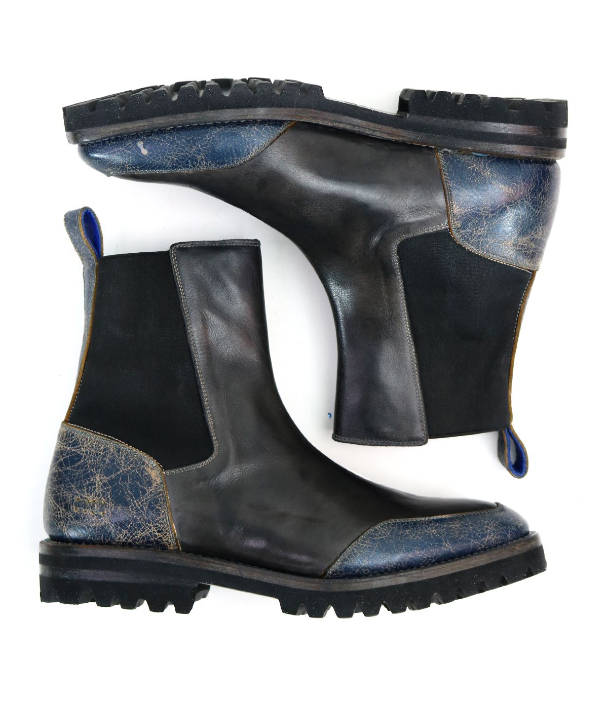 Salatiel boots by Bed Stu, featuring a black Chelsea design with textured blue accents and a leather footbed, are highlighted by their rugged black soles and displayed side by side on a pristine white background.