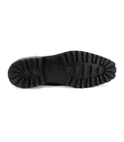Bottom view of the Salatiel Chelsea boot by Bed Stu, featuring a textured rubber sole with a variety of geometric tread patterns for enhanced grip.