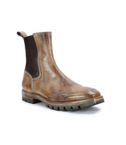 The Salatiel by Bed Stu is a brown leather Chelsea boot showcasing a textured, worn look, complemented by a black elastic side panel and a chunky, textured sole for enhanced grip.