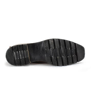 Close-up of the sole of a black Salatiel Men's Chelsea boot by Bed Stu, featuring deep tread patterns. The slightly worn appearance hints at the unmatched comfort offered by this footwear.