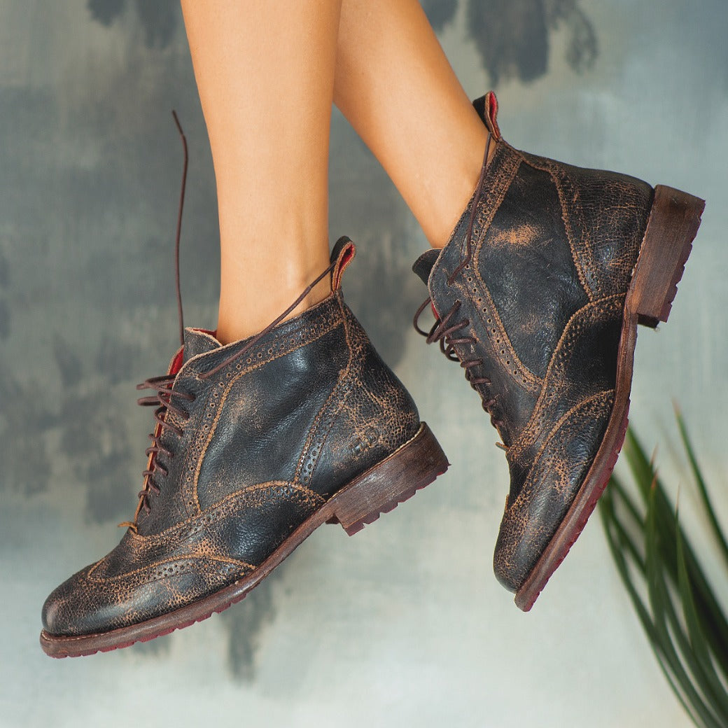 A woman wearing a pair of Bed Stu Sally wingtip boots.