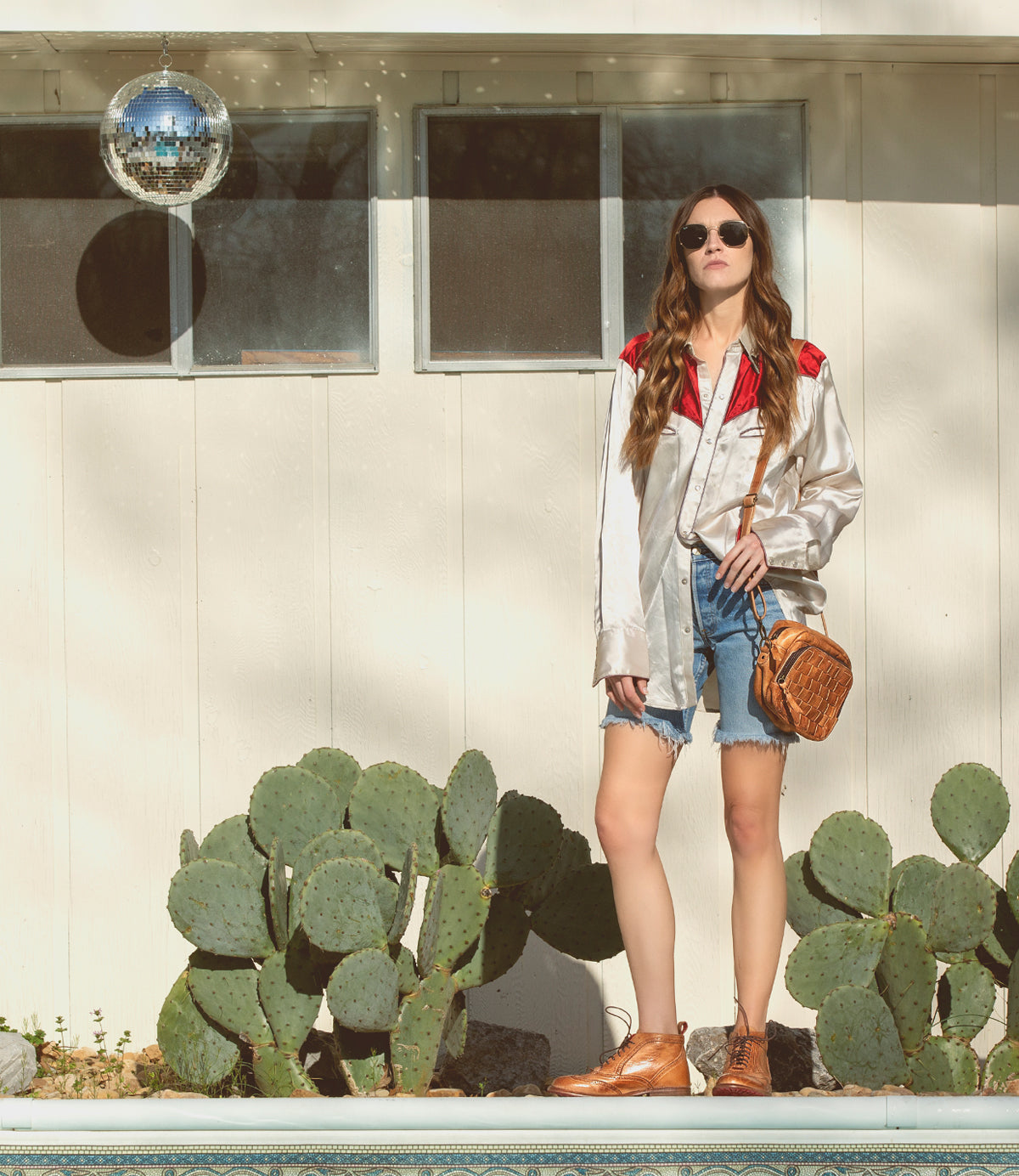 A woman wearing a pair of Bed Stu Sally wingtip boots.