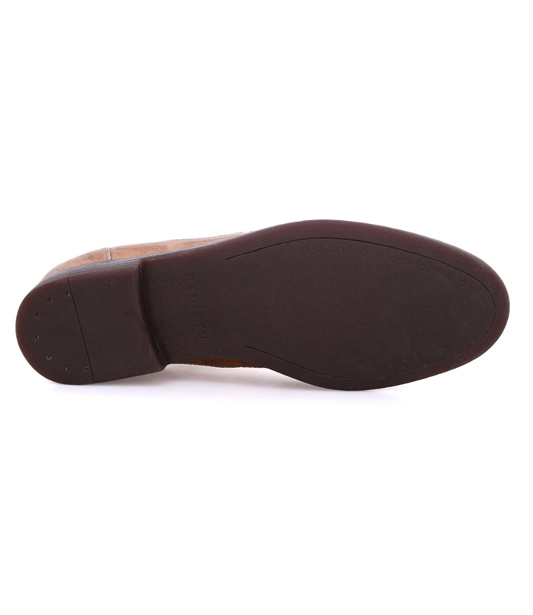 A pair of Sandro shoes with black soles on a white background.