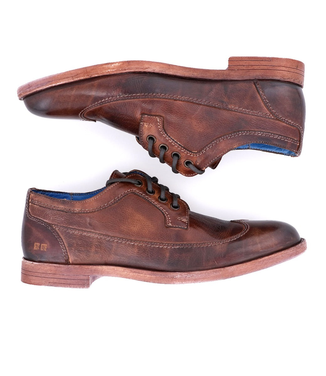 A pair of Sandro brown leather shoes with blue soles by Bed Stu.