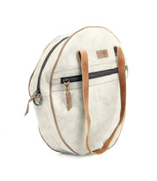 A white round Saray bag with brown leather handles by Bed Stu.