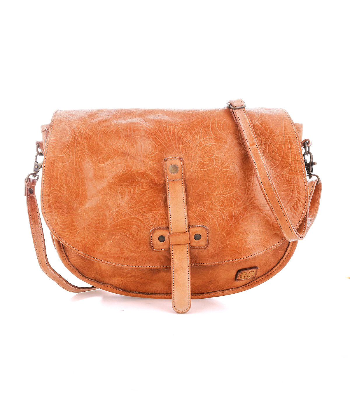 The Bed Stu Sequoia EM is a light brown vegetable-tanned leather crossbody saddle bag with a front strap closure, embossed floral pattern, and adjustable crossbody strap for comfort.