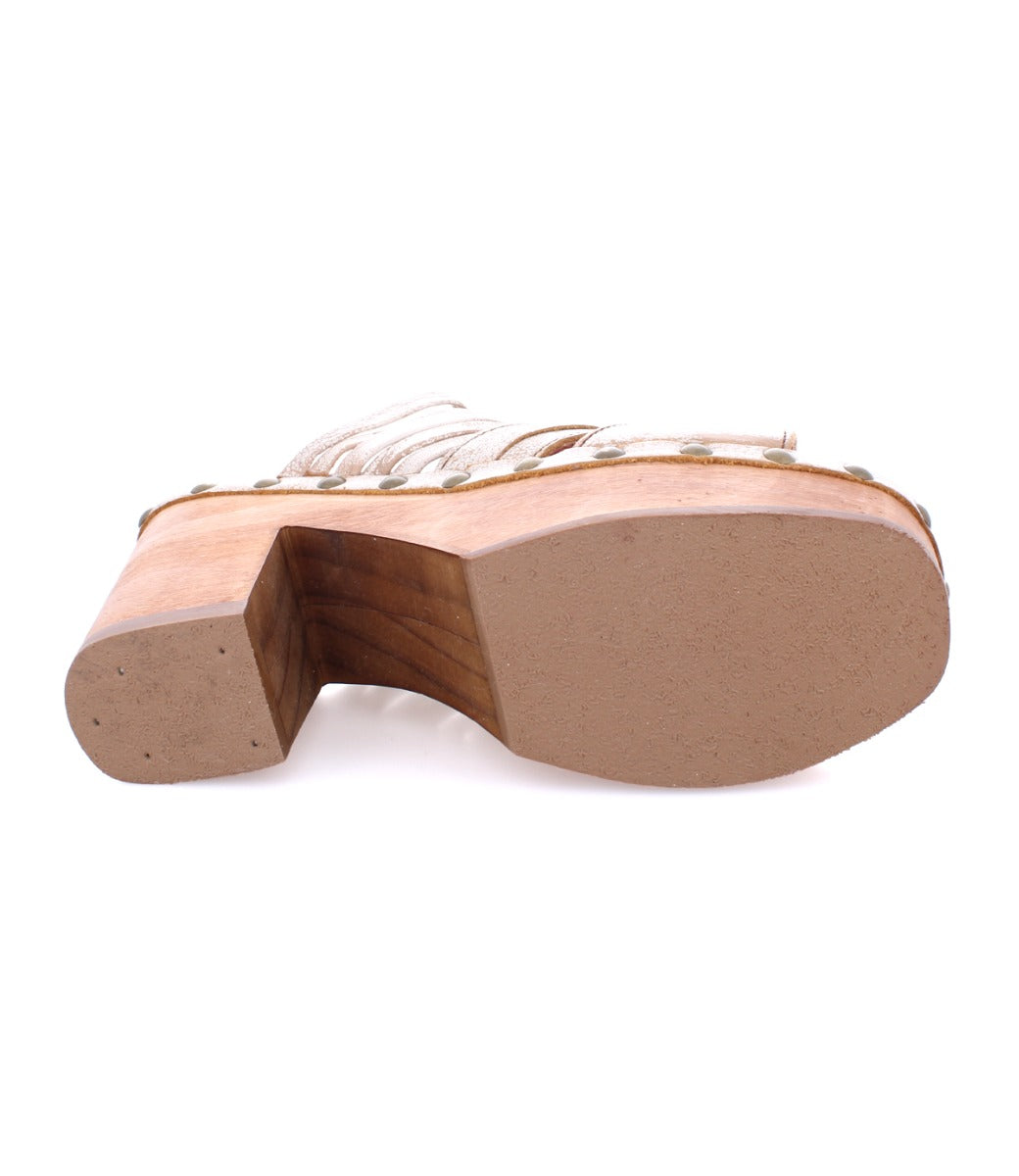 The image shows the bottom view of the Shantel wooden platform sandal by Bed|Stü, featuring a thick heel and visible screws along the edge.