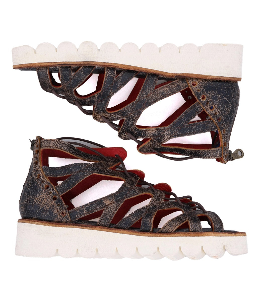 A pair of Bed Stu Shirin II brown leather sandals with red soles.